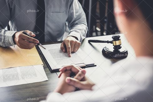 عکس با کیفیت وکیل در حال توضیح دادن قوانین به موکل خود