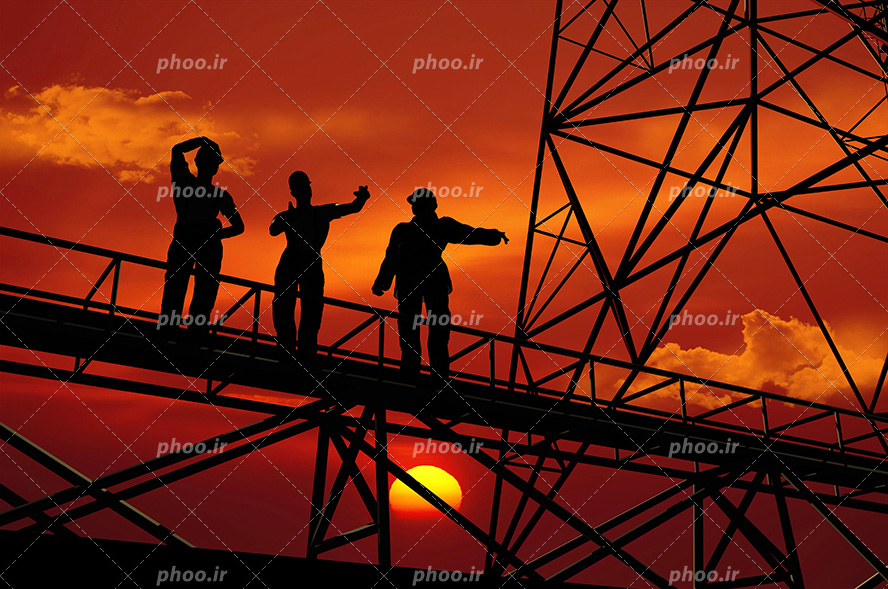 عکس با کیفیت سه مهندس ایستاده بر روی تاورکرین و آسمان در حال غروب