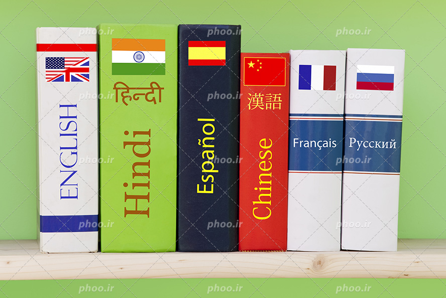 عکس با کیفیت منحصربفرد کتاب زبان های مختلف چیده شده در کنار یکدیگر در پس زمینه سبز
