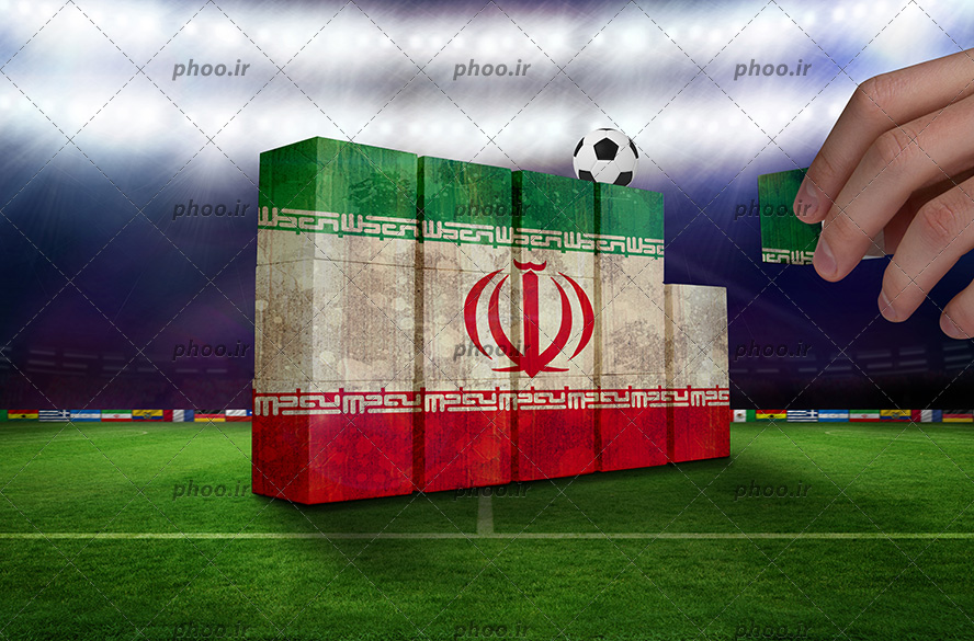 عکس پرچم ایران به شکل ستون های کوچک که روی آن یک توپ است در یک زمین فوتبال