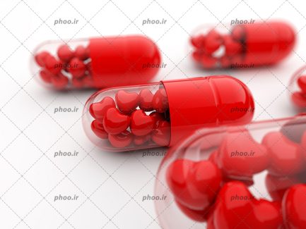 عکس قرص های کپسول قرمز با دونه های شکل قلب