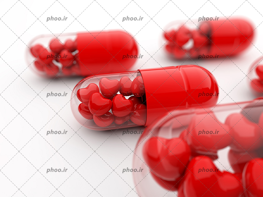 عکس قرص های کپسول قرمز با دونه های شکل قلب