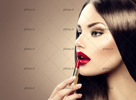عکس خانم زیبا در حال رژ لب زدن