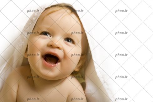 عکس با کیفیت بچه بانمک در حوله سفید در حال خندیدن