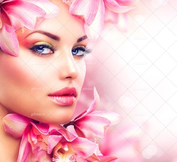 عکس با کیفیت گل های لیلیوم به رنگ صورتی بر روی سر و صورت زن زیبا با چشم های آبی زیبا