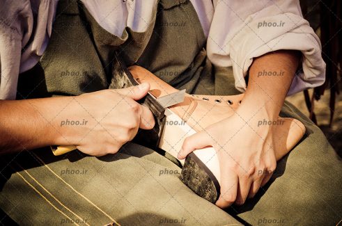 عکس کفاش درحال قالب در آوردن برای کفش