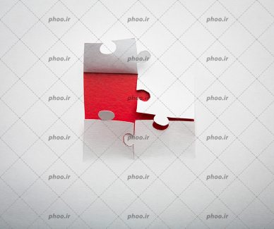 عکس با کیفیت برش کاغذ سفید به شکل پازل در پس زمینه قرمز