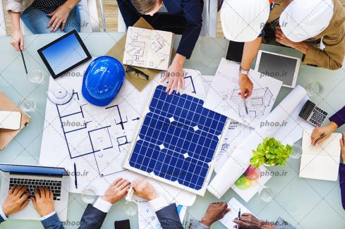عکس زیبا کار کردن مهندسان سر میز با لب تاپ و مداد نقشه