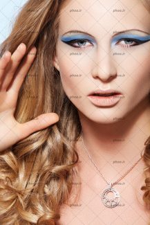 عکس یک خانم با آرایش چشم و سایه چشم آبی رنگ و یک آویز گردن
