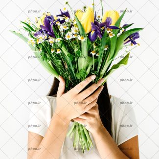 عکس دسته گل طبیعی با گل های بنفش و زرد در دست یک خانم با زمینه سفید