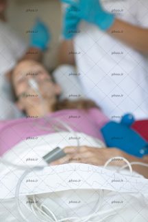 عکس بیمار روی تخت در حال بیهوش شدن توسط دکتر